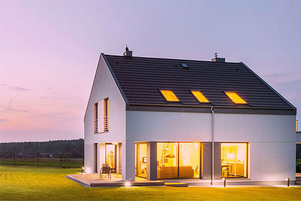 single family home at dusk with the interior lights on
