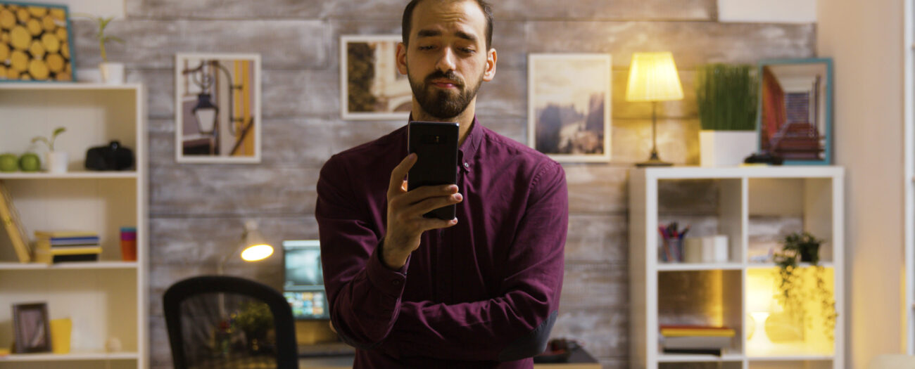 man in office choosing smart home devices on phone