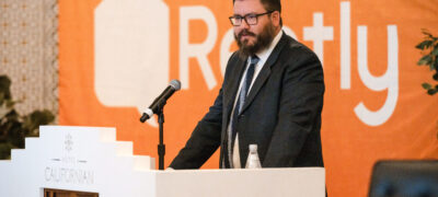 Merrick Lackner, Rently CEO and Founder speaking at the podium during the Rently Summit 2022