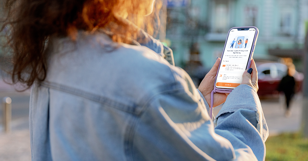 woman holding her phone while on a self guided tour