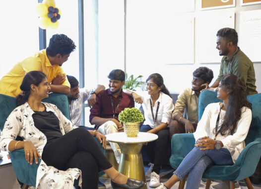 Rently India Team sitting around coffee table and smiling