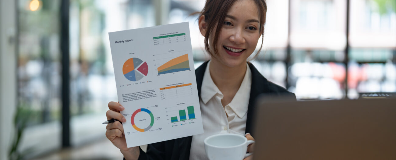 Woman presents a document with data charts during a virtual meeting showing how Smart Home Installation Increase NOI