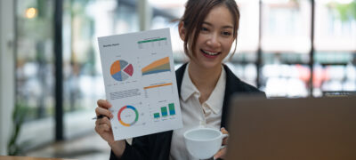 Woman presents a document with data charts during a virtual meeting showing how Smart Home Installation Increase NOI