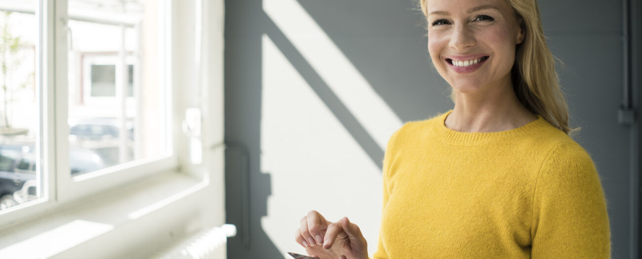 Woman Managing Multifamily Rental Properties from her mobile device