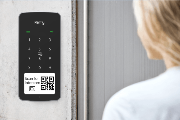 woman uses an access panel with intercom smart access control system