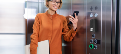 woman in elevator with Rently Access Panel with Intercom on the wall